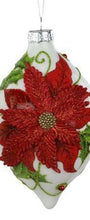 A white Christmas ornament shaped like a teardrop, featuring a large red poinsettia flower with green leaves and a silver hanging cap.