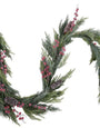 A festive artificial Christmas wreath made of green pine branches, decorated with clusters of pink berries and several pinecones, shown against a plain white background.