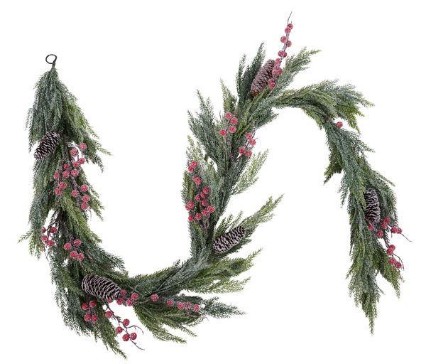 A festive artificial Christmas wreath made of green pine branches, decorated with clusters of pink berries and several pinecones, shown against a plain white background.