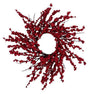 A festive artificial berry wreath featuring dense clusters of deep red berries on dark brown branches, arranged in a circular wreath shape against a solid white background.