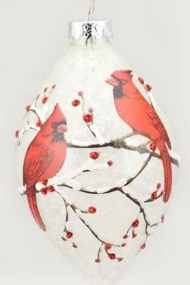 A white Christmas ornament shaped like a teardrop, decorated with two red cardinals perched on branches with small red berries, hanging from a silver cap.
