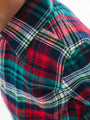 Close-up of a plaid shirt with red, green, and blue patterns.