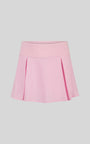Pink pleated skirt on a light gray background