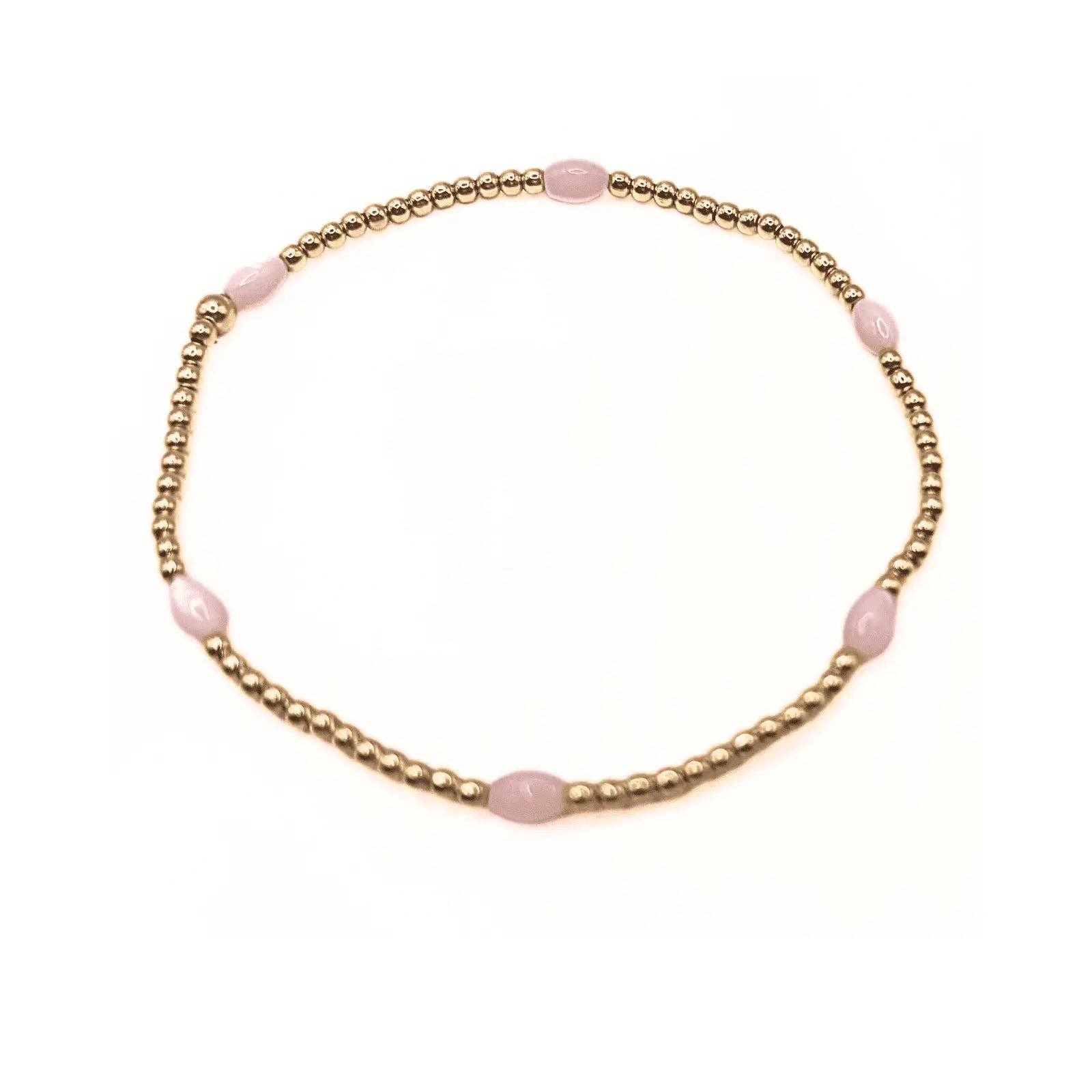 Bracelet with pink beads on a gold chain against a white background