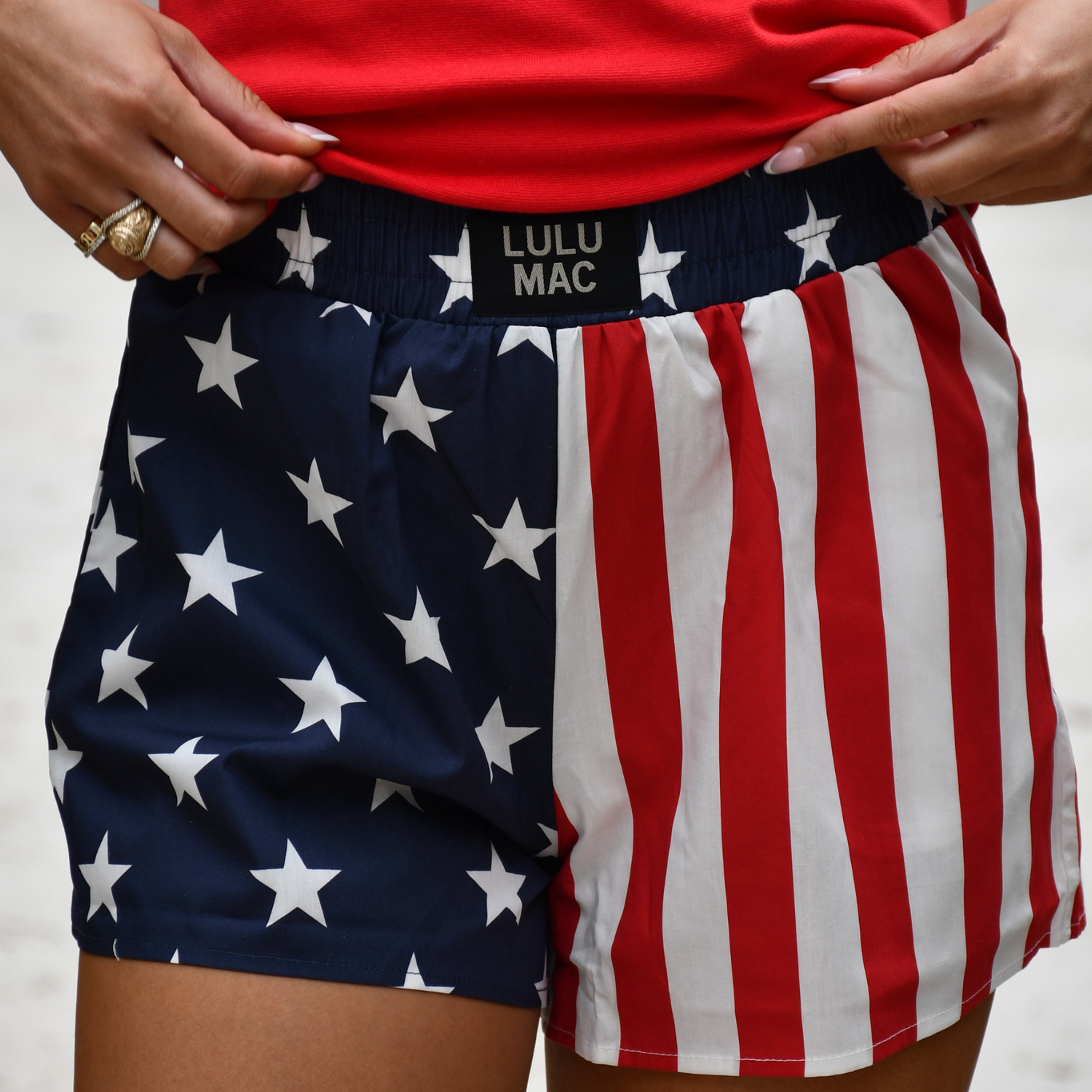 American flag patterned shorts with a visible brand label on a neutral background