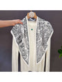 Triangle scarf draped in a V shape, black and white abstract pattern