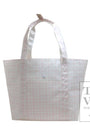 White tote bag with a subtle pink pattern on a white background, featuring the TRVL Design logo.