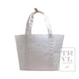 White tote bag with a subtle pink pattern on a white background, featuring the TRVL Design logo.
