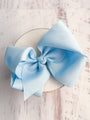 Large light blue bow on a white background