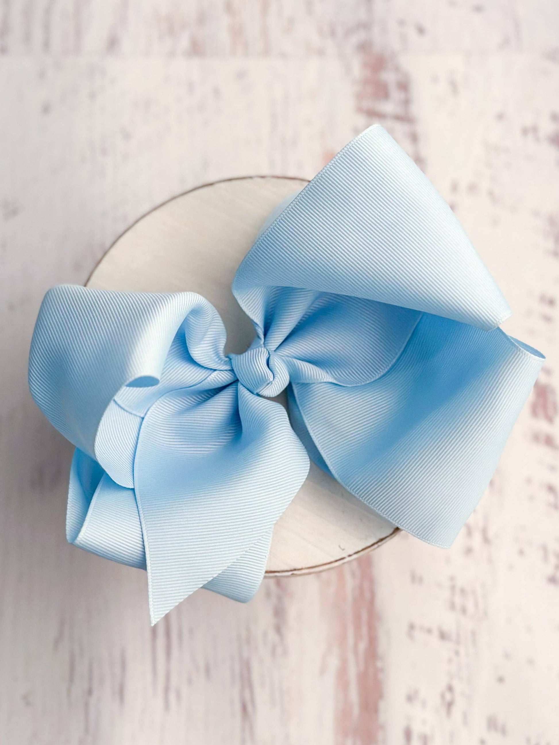 Large light blue bow on a white background