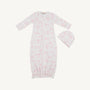 Baby gown and hat set with pink floral pattern on a white background