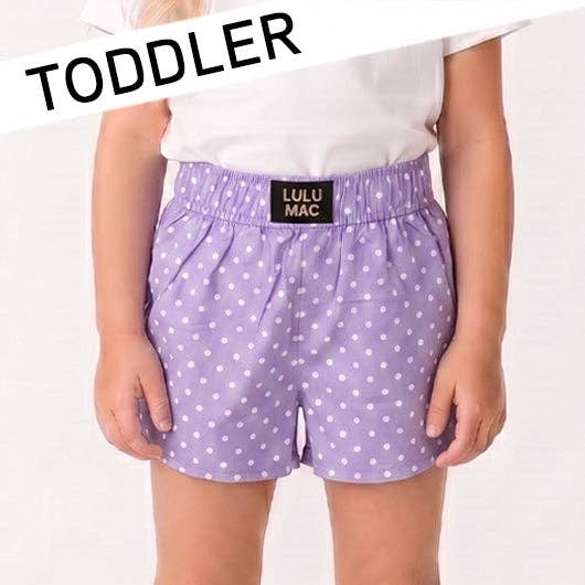Purple polka dot shorts with a visible brand label on a white background, labeled 'TODDLER'.