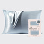 Silver satin pillowcase on a light gray background with a brand label.