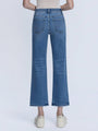 Blue jeans worn by a person on a white background
