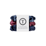 A set of three Teleties hair scrunchies in navy blue, dusty blue, and burgundy, wrapped together with a white paper label featuring the Teleties logo.