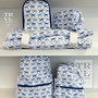Set of blue and white patterned bags and nap mats on a shelf with 'TRVL Design' branding.