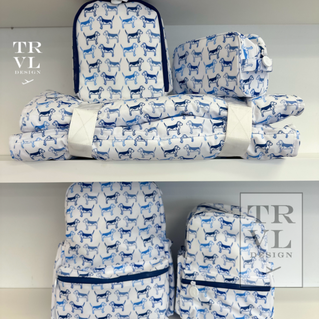 Set of blue and white patterned bags and nap mats on a shelf with 'TRVL Design' branding.