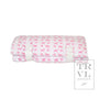Folded fabric nap mat with pink dog pattern on a white background