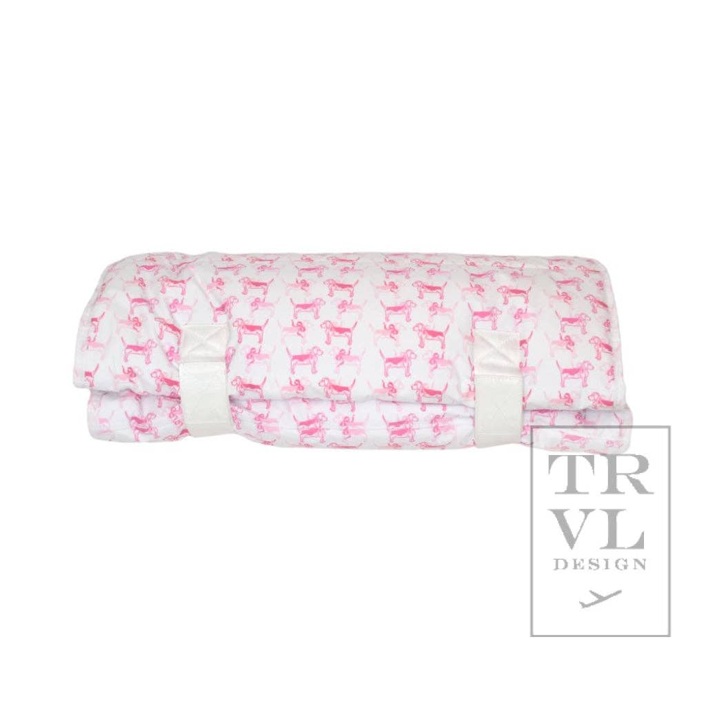 Folded fabric nap mat with pink dog pattern on a white background