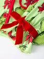 Green fabric with red bows and Grinch design on a white background