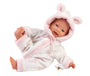 Baby doll in a pink and white outfit with a hood on a white background