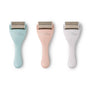 Three skin care rollers with different colored handles on a white background