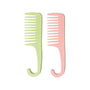 Two combs, one green and one pink, on a white background