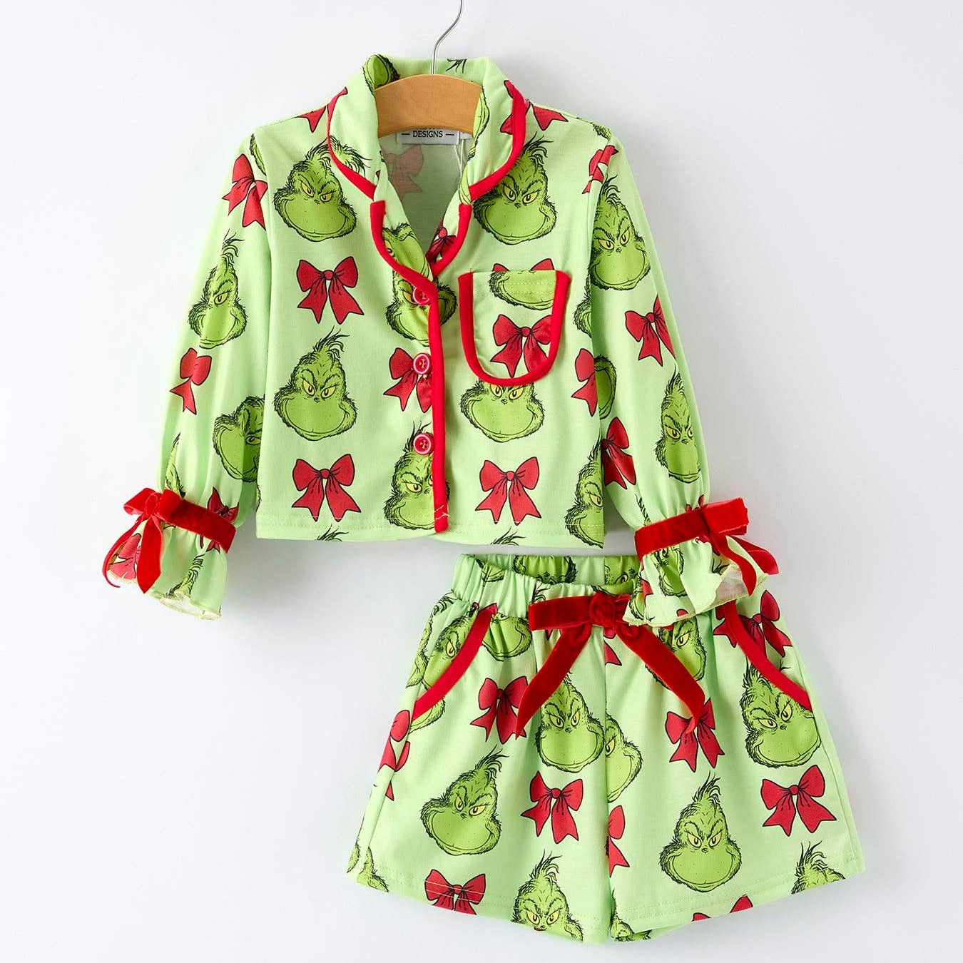 Children's pajama set with Grinch print on a white background