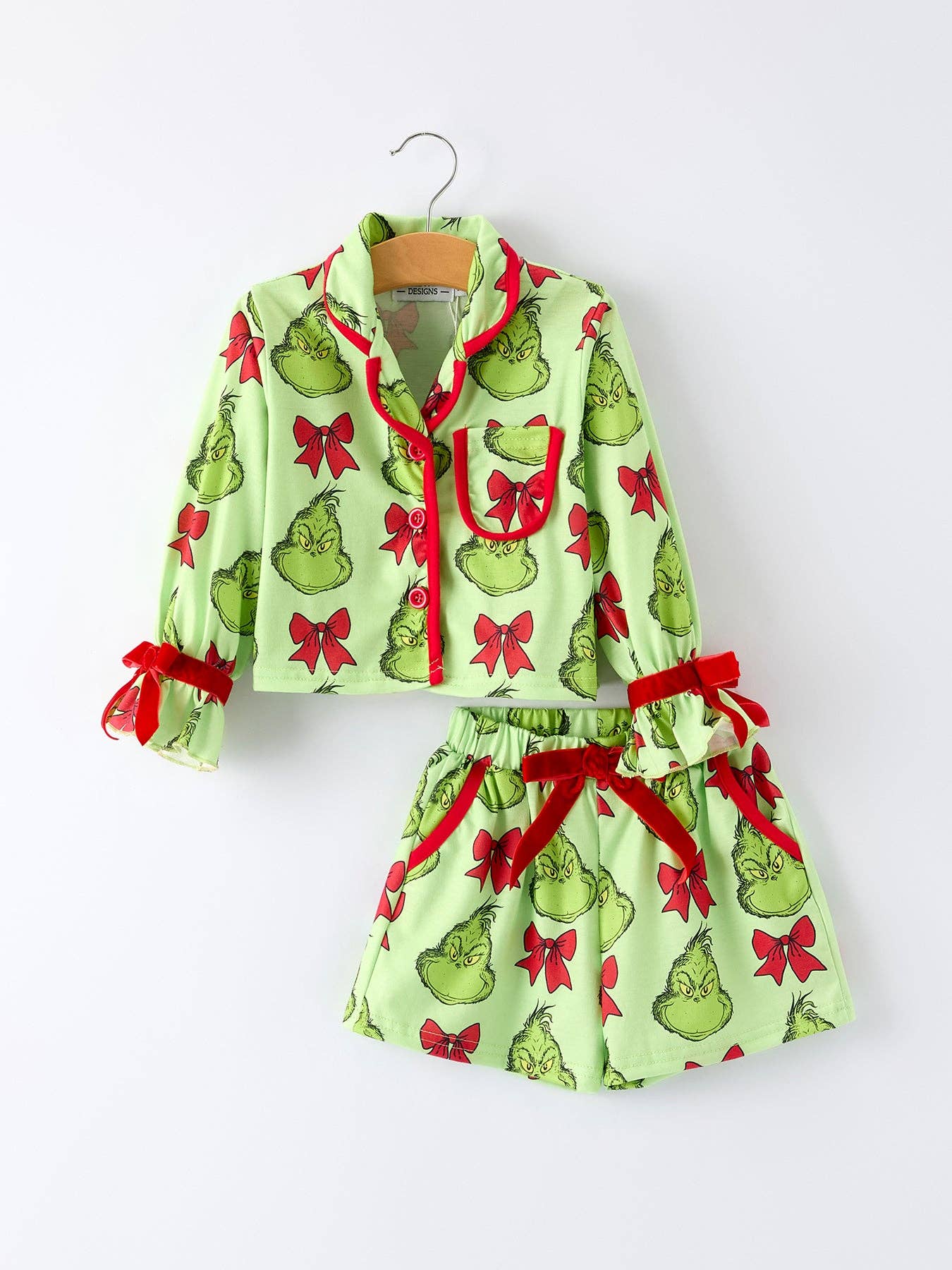 Children's pajama set with Grinch print on a white background