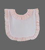 A light pink and white baby bib with ruffled trim, shown flat against a solid gray background.
