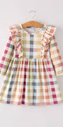 Plaid dress with ruffled sleeves on a hanger against a white background