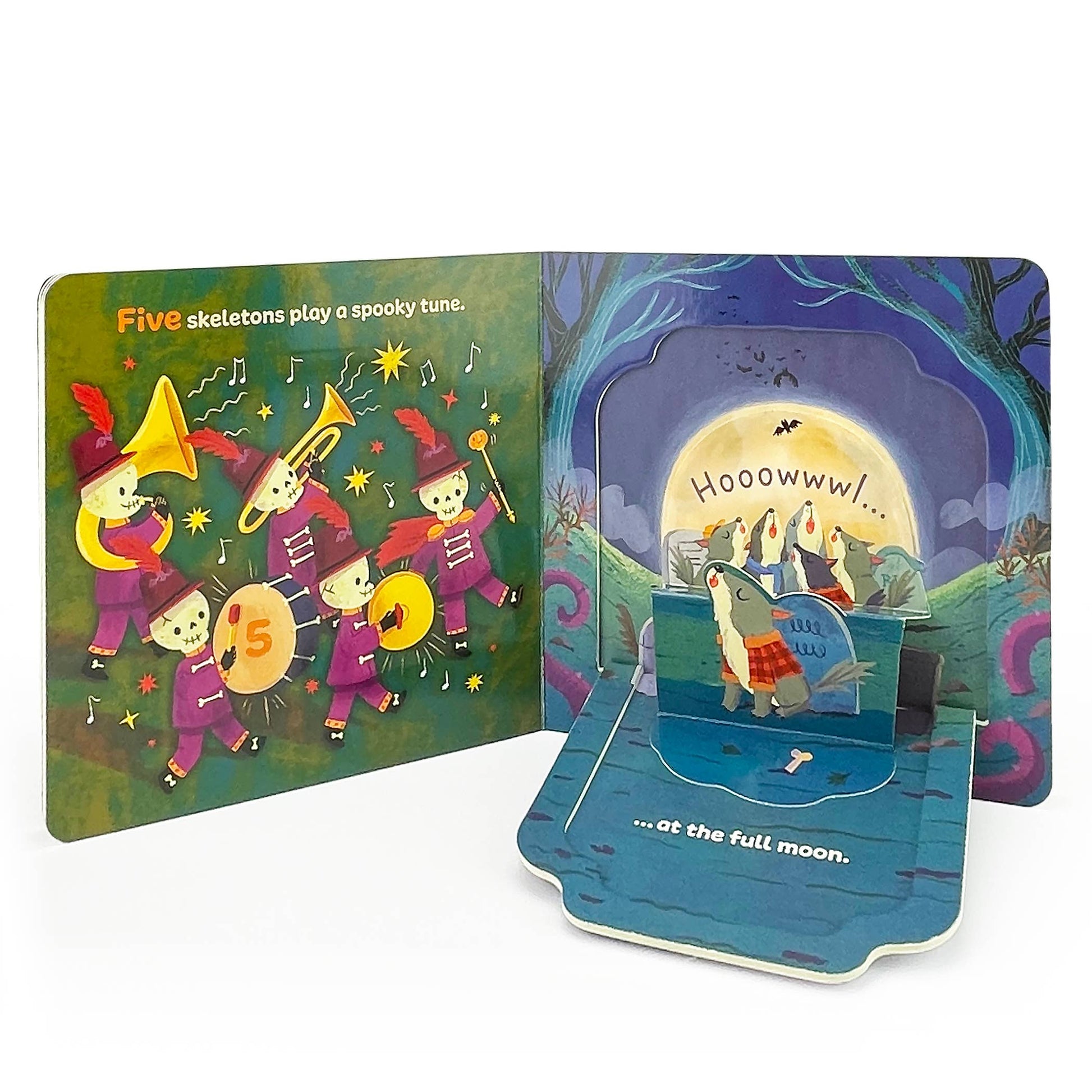 Pop-up children's book with skeletons playing music and wolfs under a full moon.