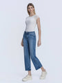Woman wearing a white top and blue jeans on a light gray background