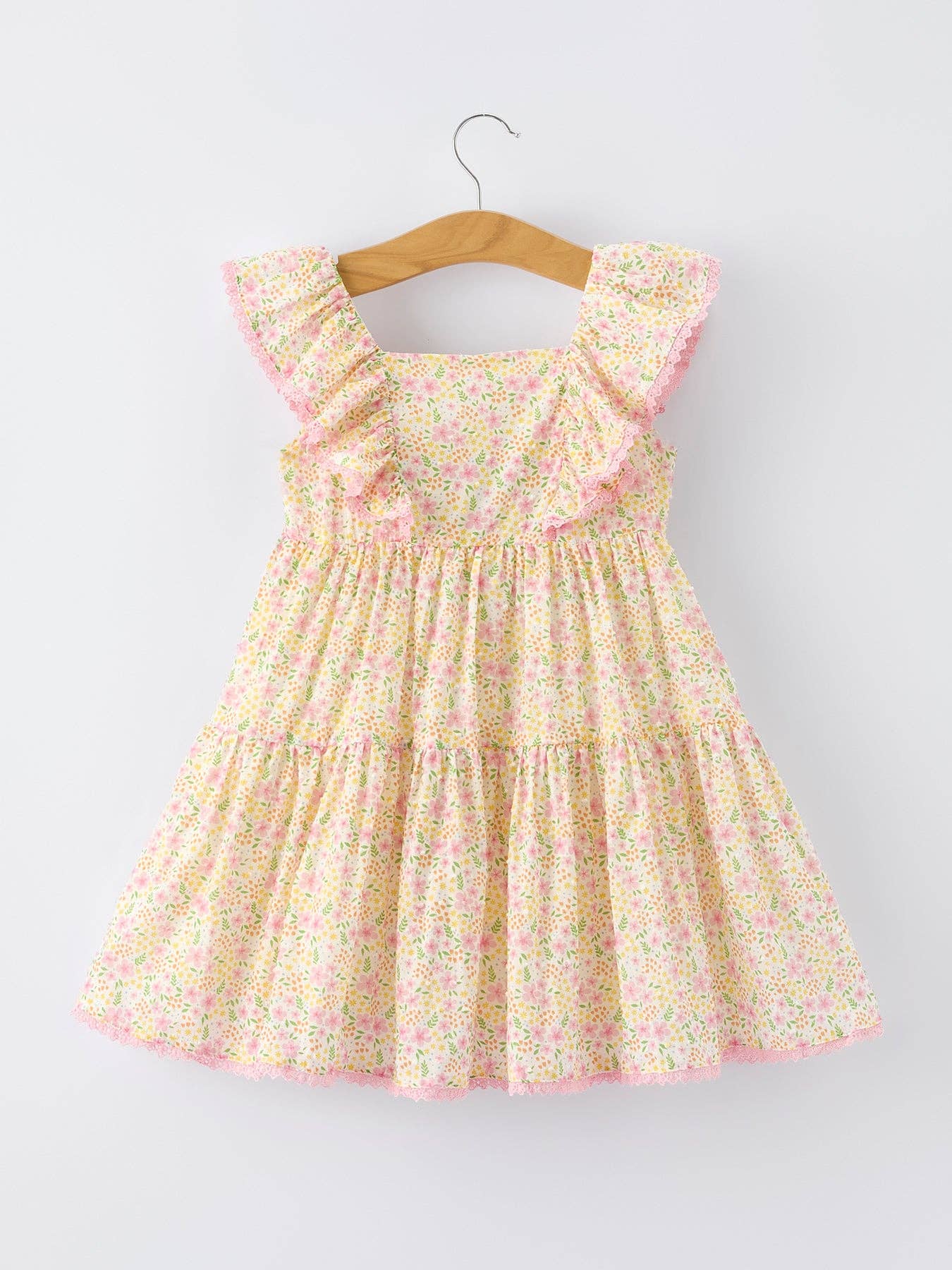 Floral dress on a hanger against a light gray background