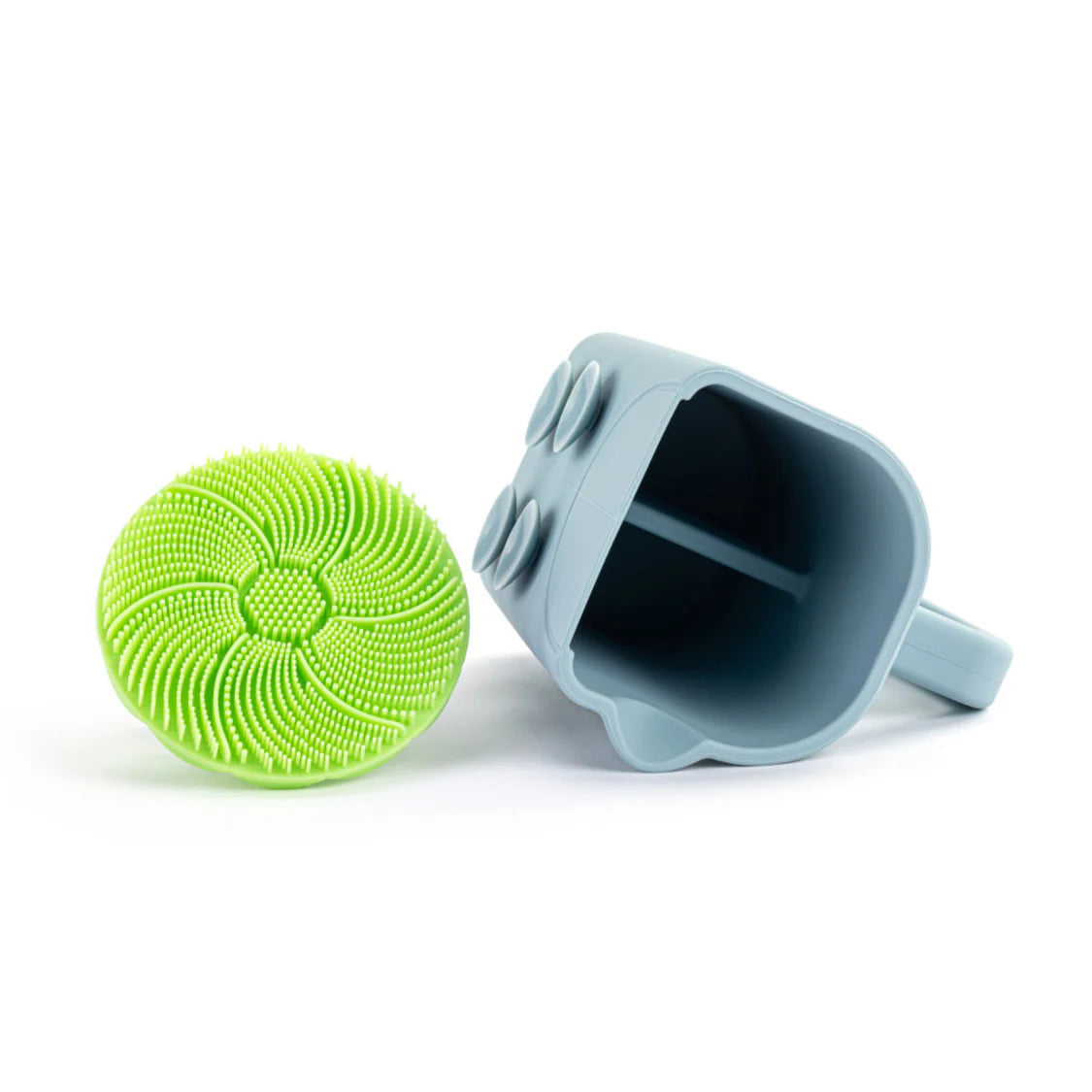 Green scrubber and blue cleaning tool on a white background