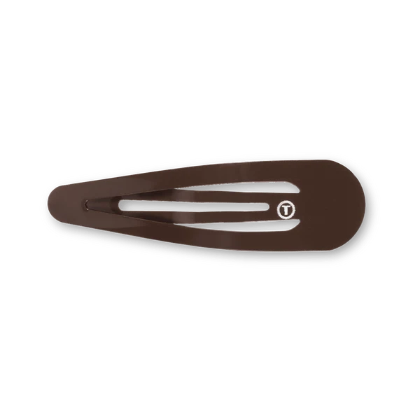 A dark brown hair clip with a small white circular logo containing a 'T' on the front, shown on a clean white background.