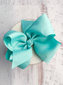 Large turquoise bow on a white background