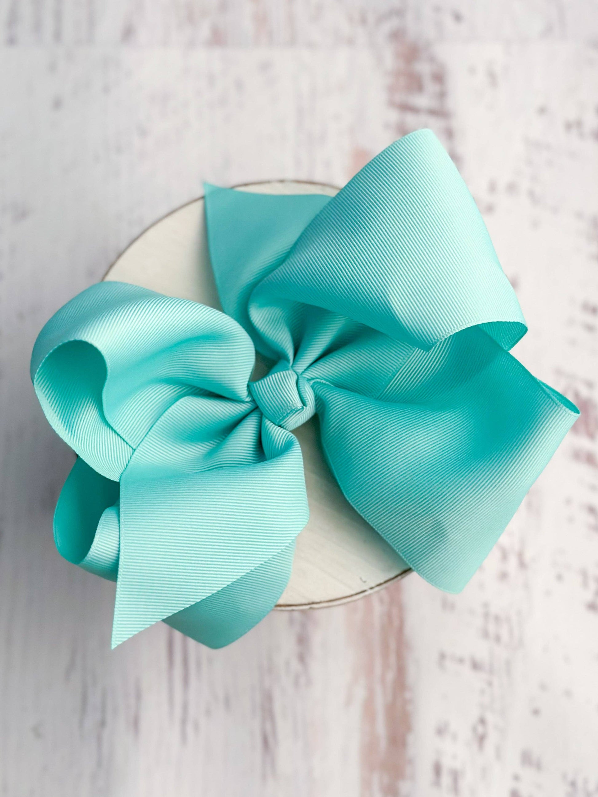 Large turquoise bow on a white background