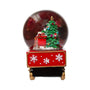 A Christmas-themed snow globe figurine featuring a green decorated tree, a red gift sack, and a red base with white snowflakes, set against a plain white background.