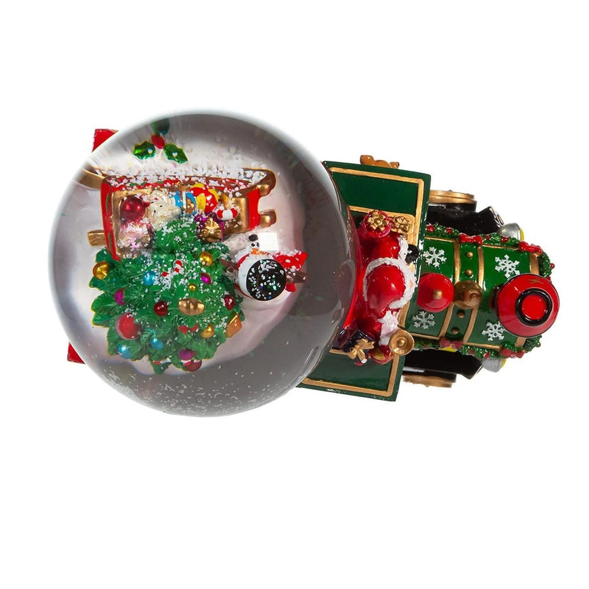 A Christmas-themed snow globe figurine featuring Santa Claus in a red sleigh on a green train, with a miniature decorated Christmas tree inside a clear glass globe.