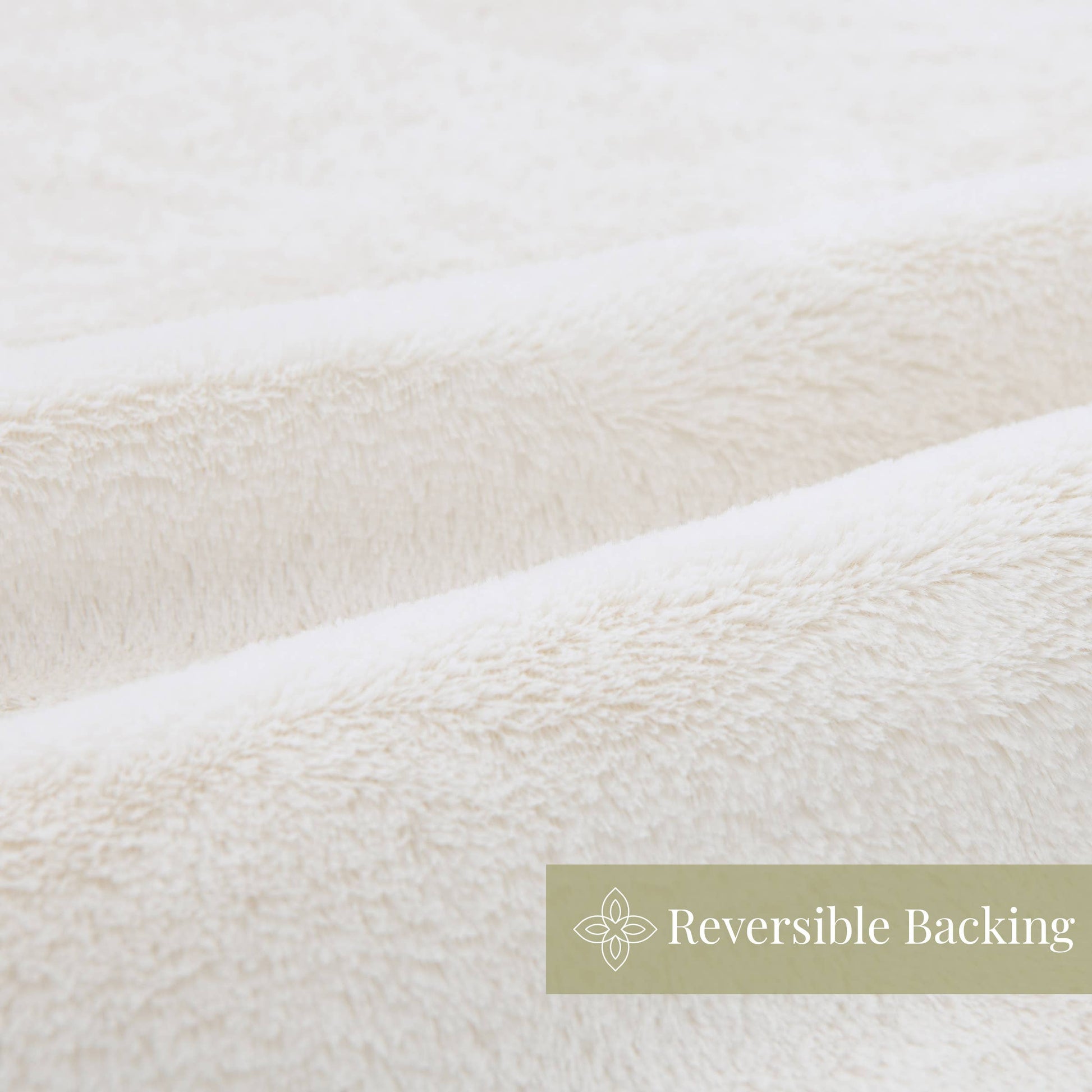 Close-up of white fabric with 'Reversible Backing' label
