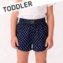 Navy blue polka dot shorts with a visible brand label on a white background, labeled 'TODDLER'.