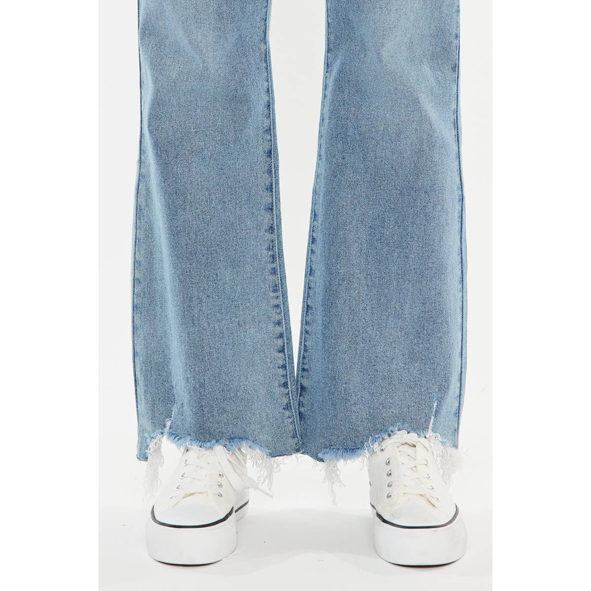 Light blue jeans with white sneakers on a white background