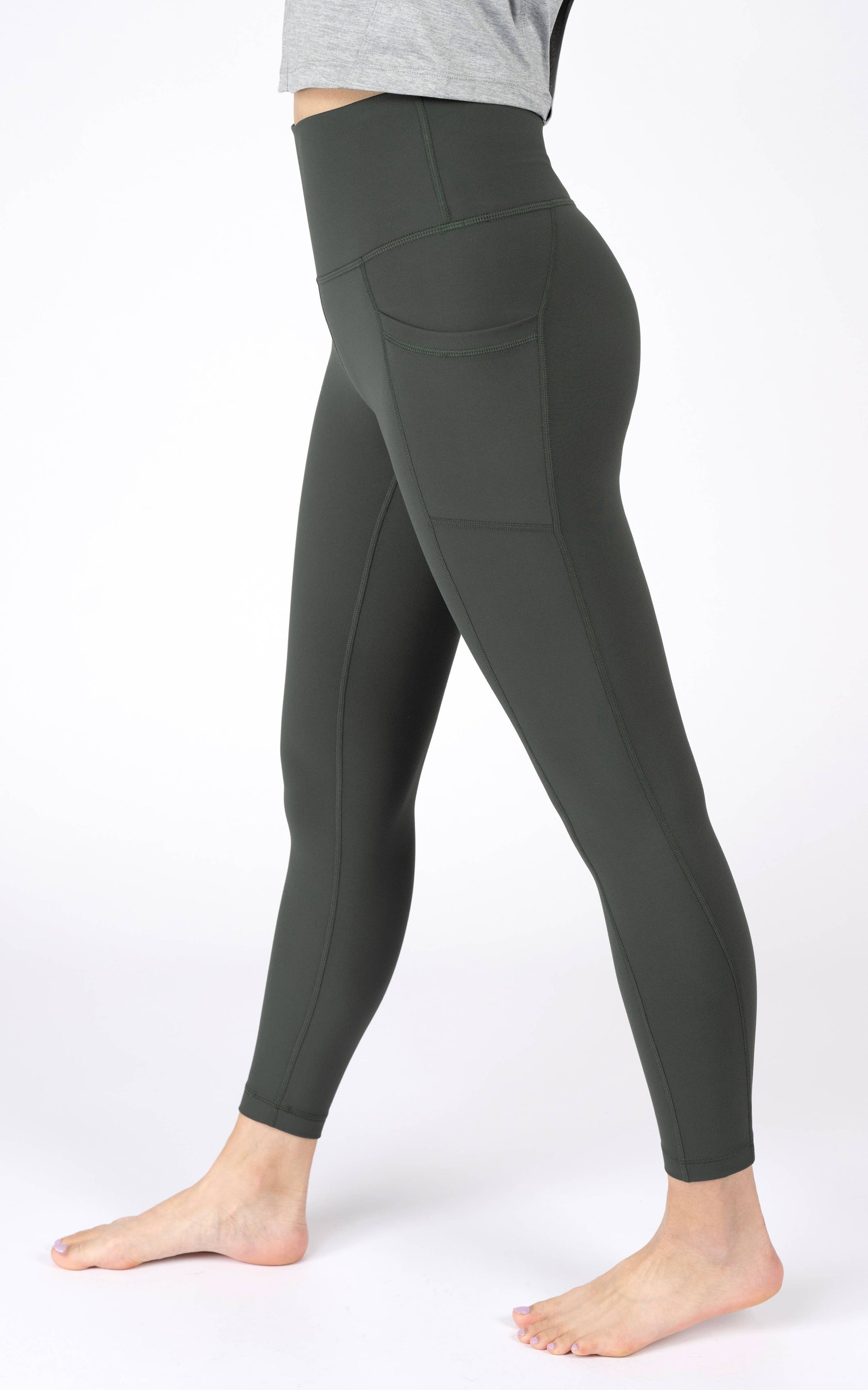 Dark gray leggings worn by a person on a white background