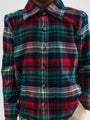 Plaid shirt with red, green, and white pattern on a plain background