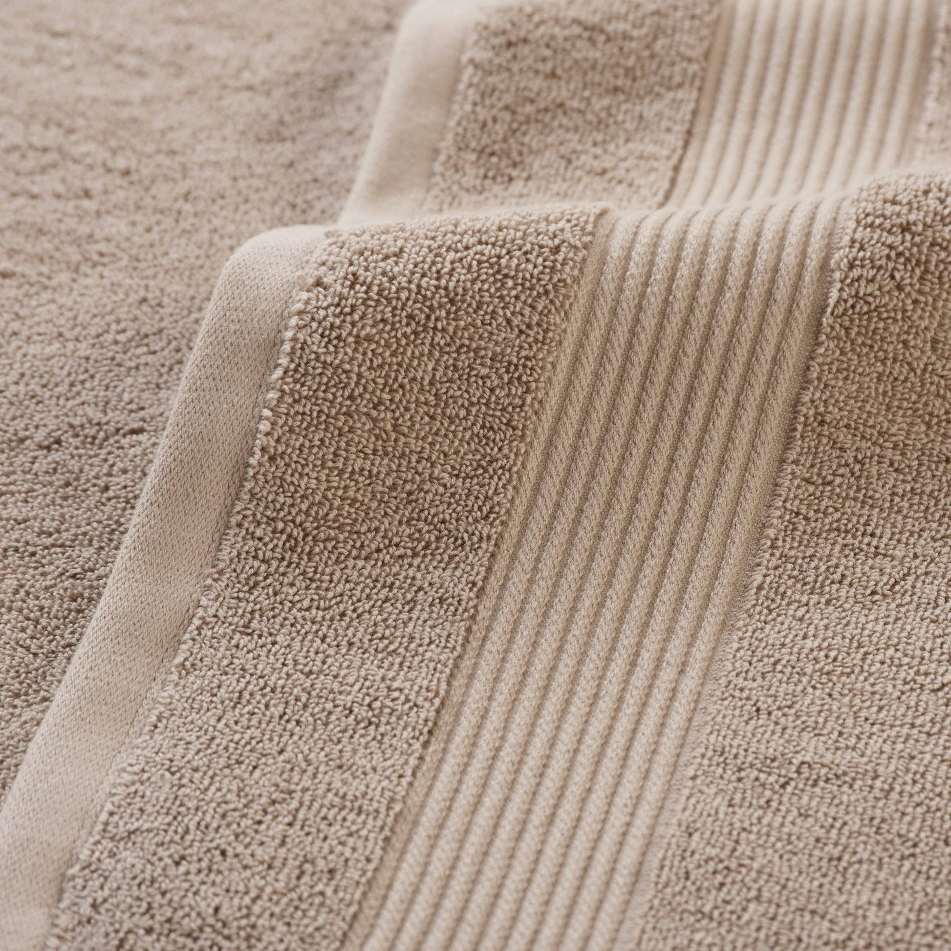 Close-up of beige textured fabric with ribbed pattern