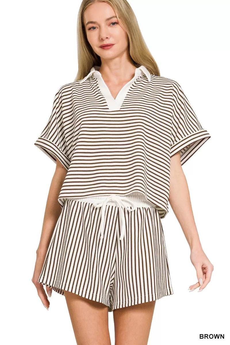 Woman wearing a striped outfit with a top and shorts on a white background