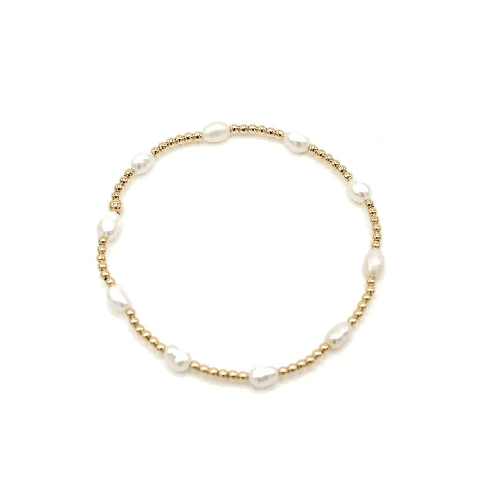 Pearl bracelet with gold accents on a white background