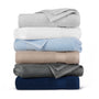Stack of folded towels in various colors on a white background