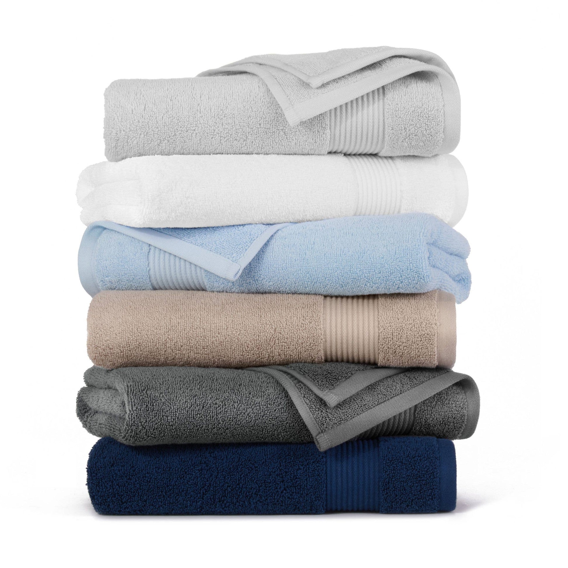 Stack of folded towels in various colors on a white background